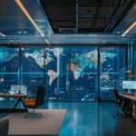 a sleek, modern office workspace is filled with sophisticated technology, showcasing a digital display on a large screen elucidating the intricate processes of kyc, highlighted by warm, focused lighting to emphasize the importance of customer verification.
